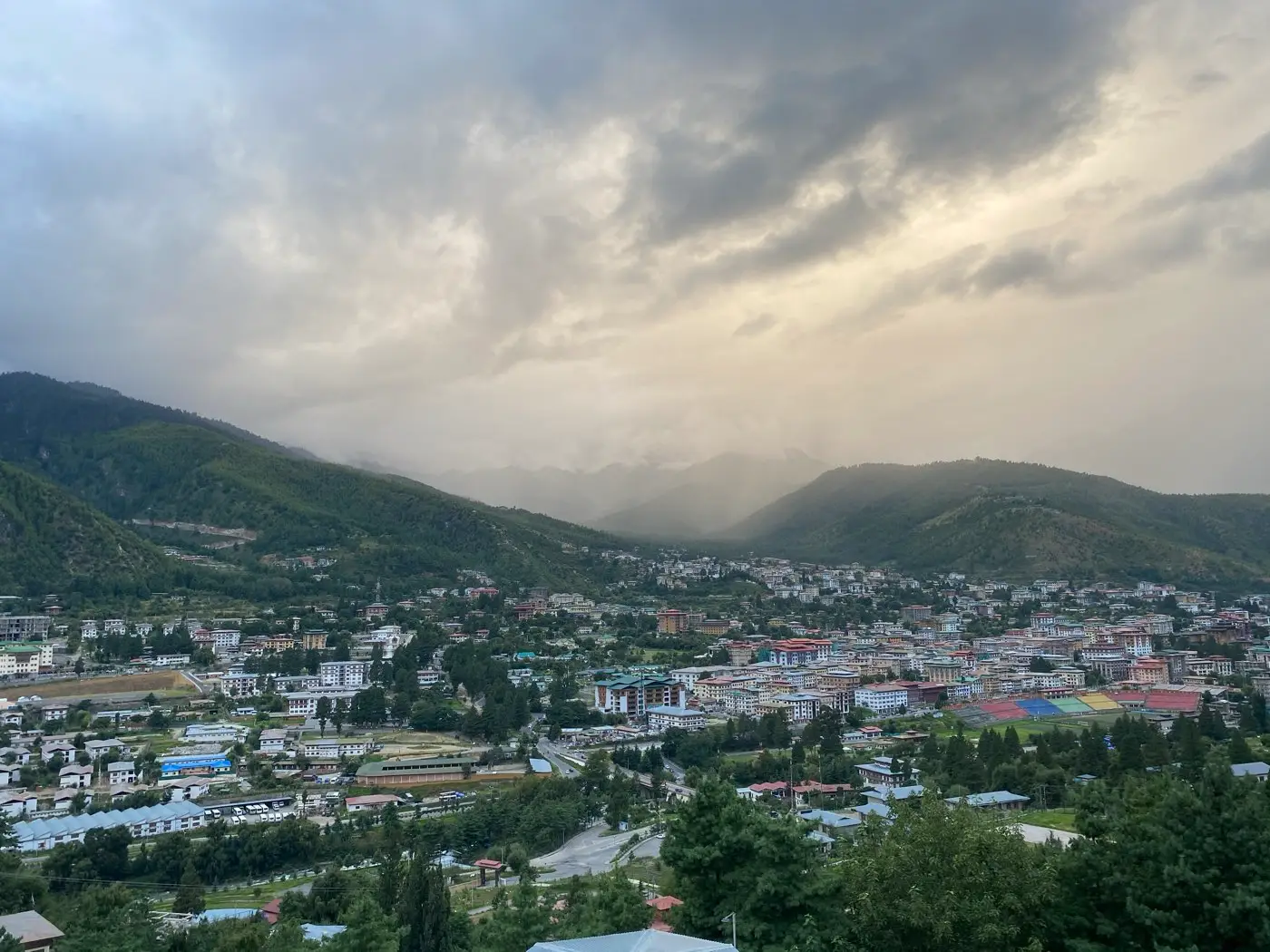 Clouds drifting over Thimphu valley and the city below