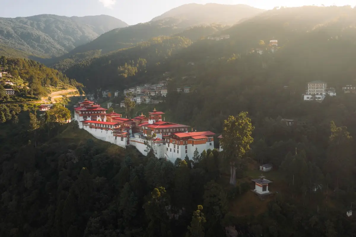 Trongsa Dzong lit by evening sun above a deep gorge
