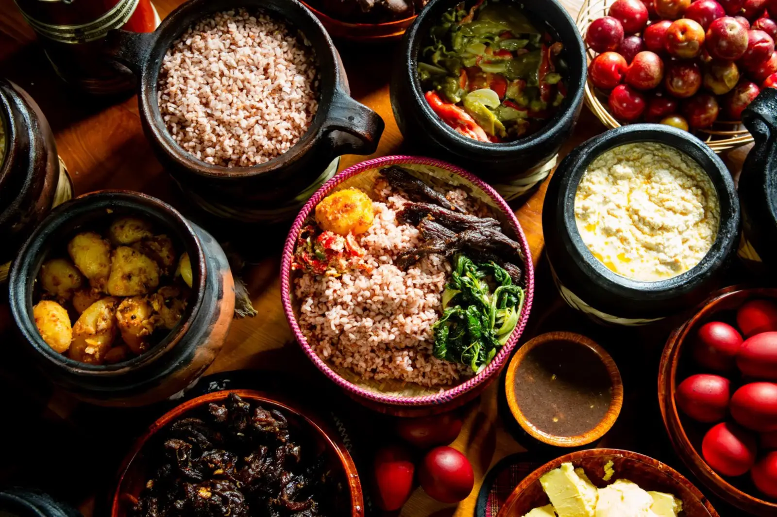 Traditional Bhutanese meal of red rice, dried beef, chillies and cheese in clay pots