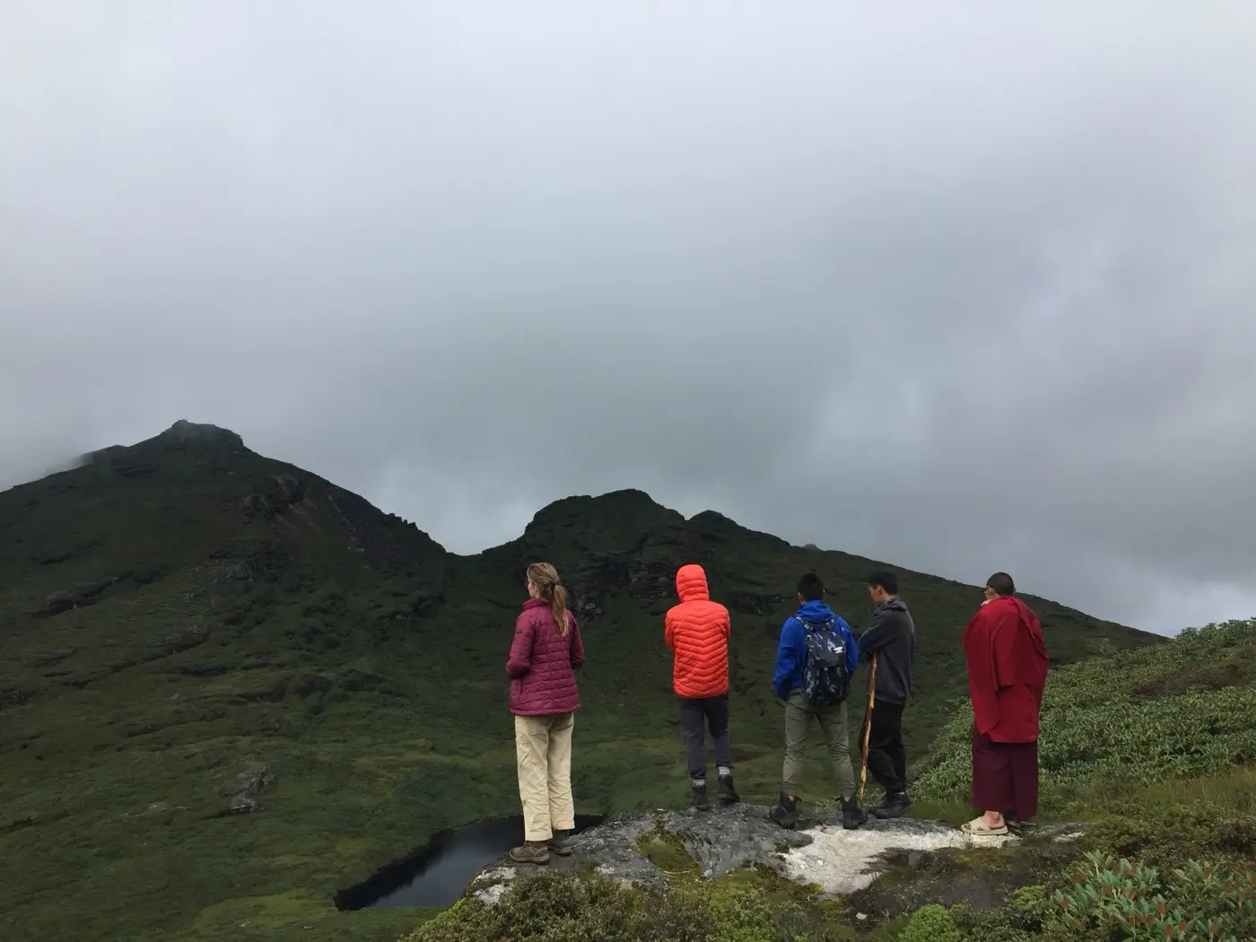 Hikers looking out over misty Himalayan ridges